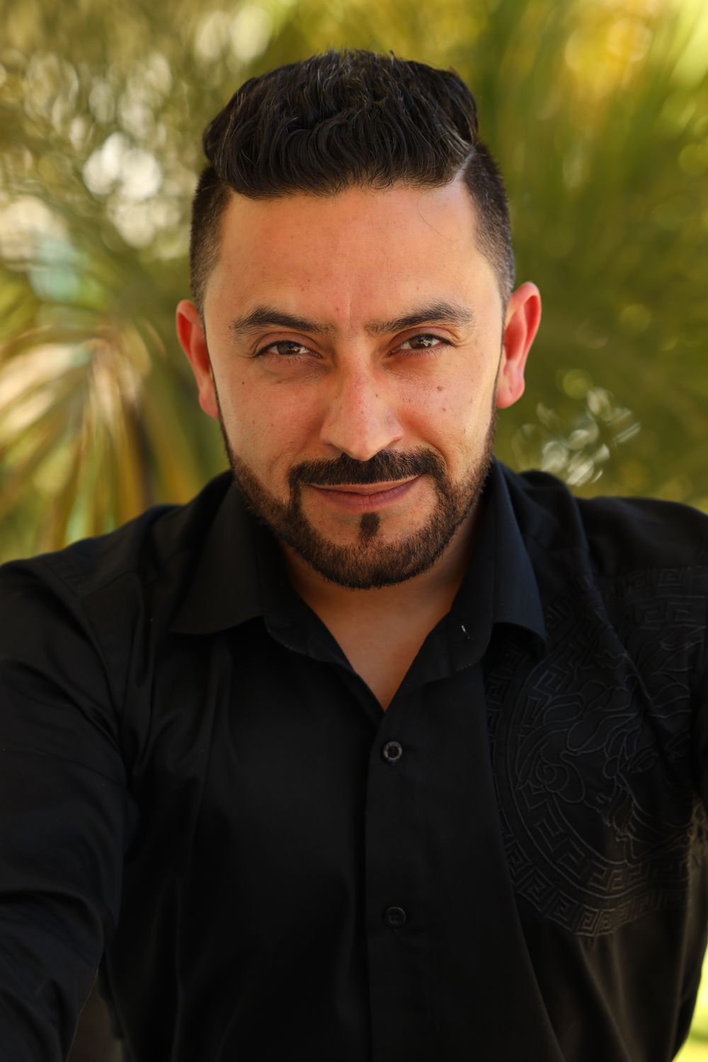 Portrait of client Marcus Bell, a bearded man in a black shirt
