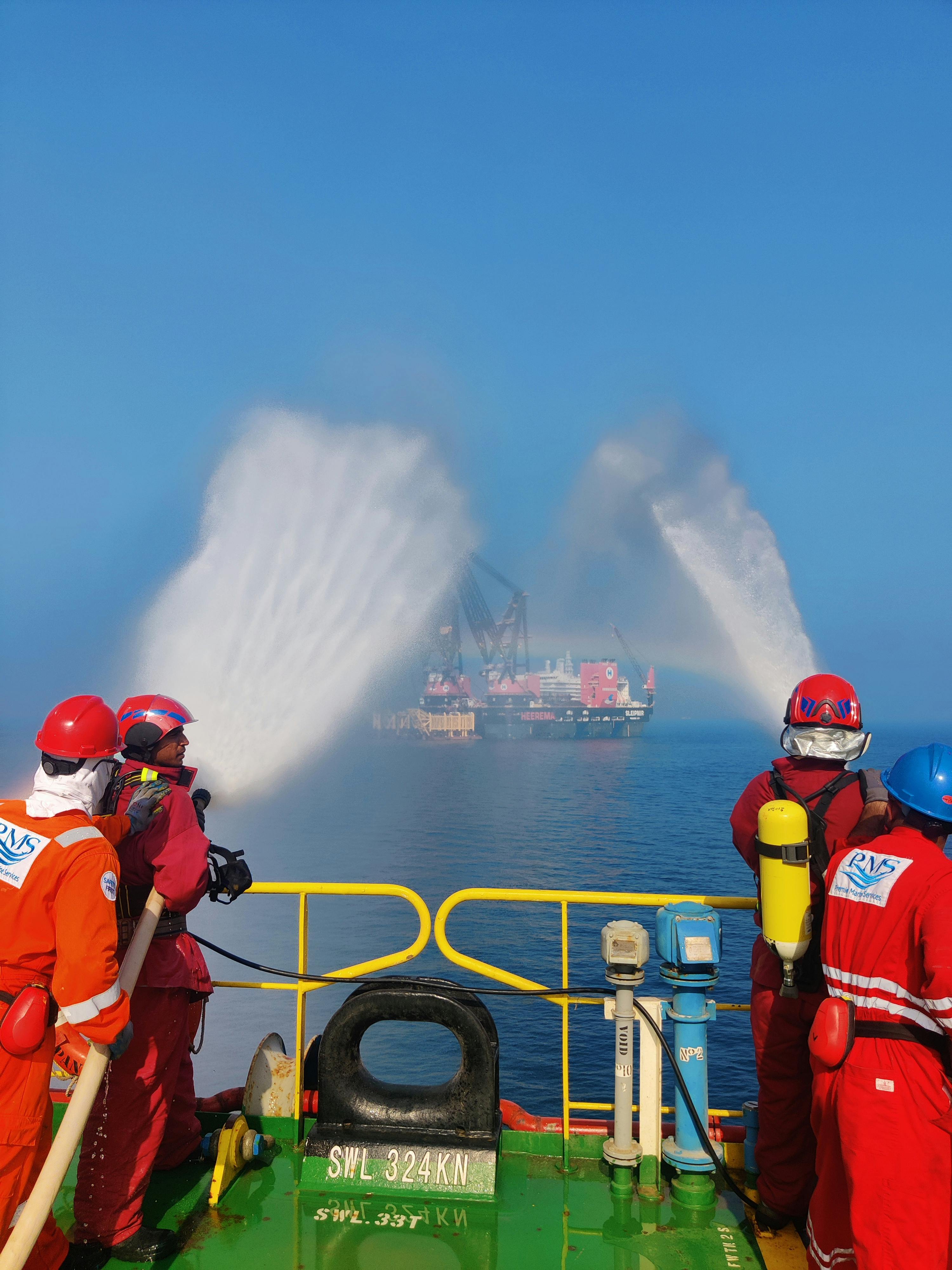 men pouring water from a boat