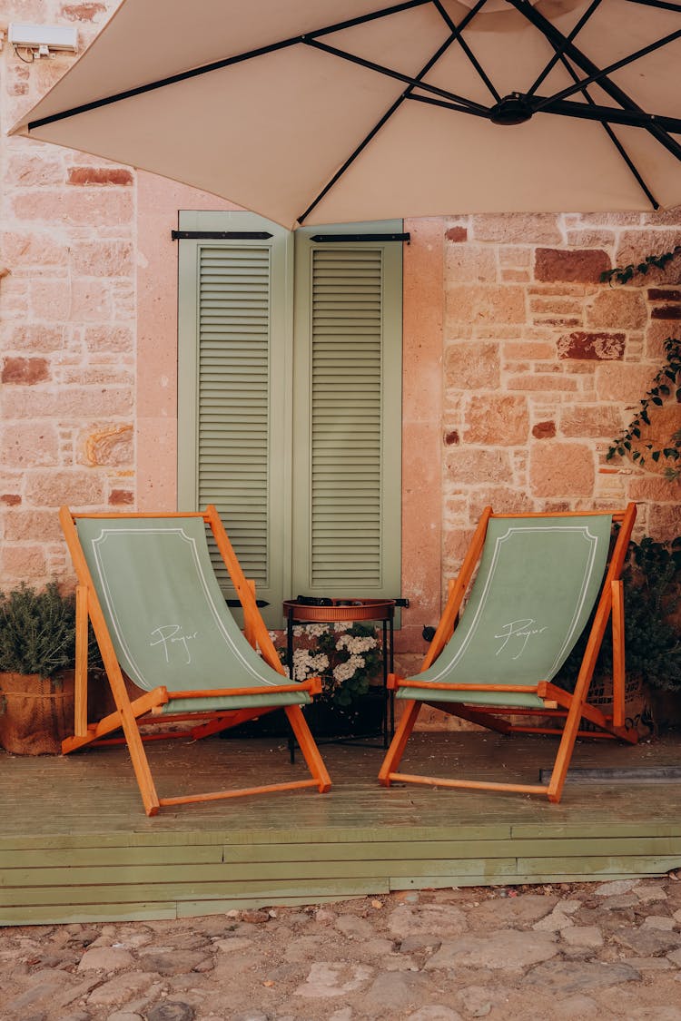 Deckchairs Under A Patio Umbrella