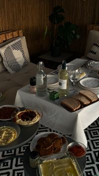 A cozy indoor dining setup with various dishes and beverages set in Balıkesir, Türkiye.