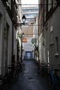 Bikes in Narrow Alley in Town