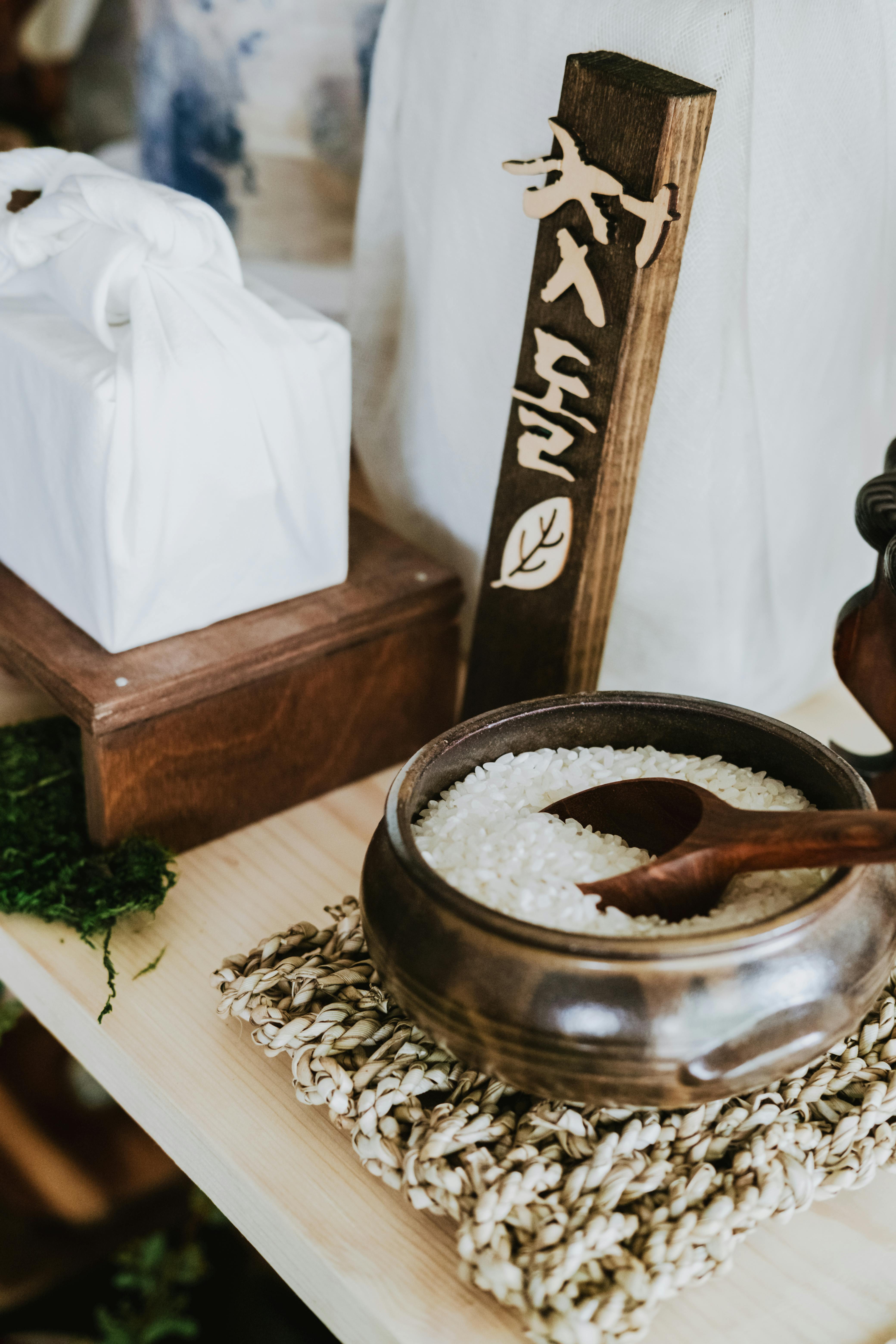 a bowl with rice and a wooden spoon