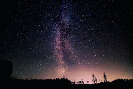A stunning night view of the Milky Way galaxy over a serene landscape, perfect for nature wallpapers.