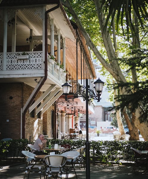 Men Sitting at Table in Sidewalk Cafe