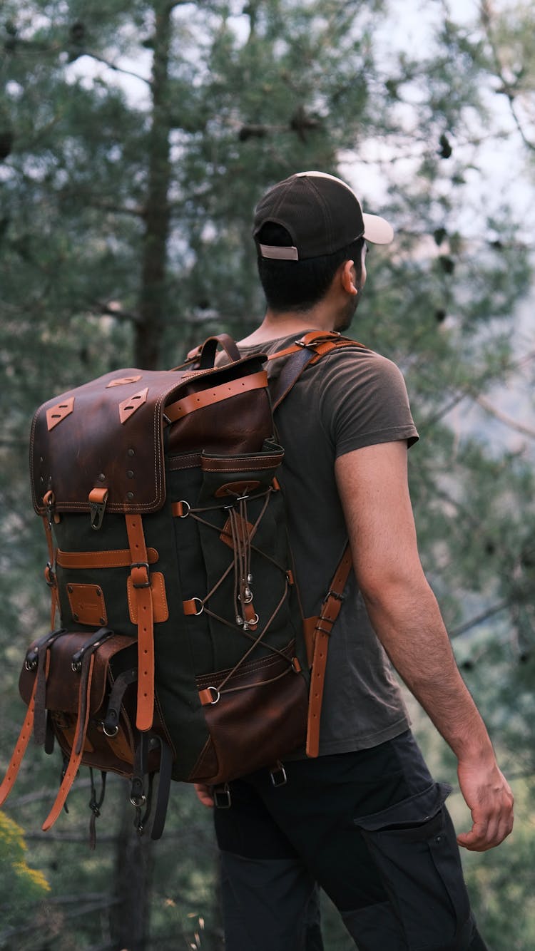 Man With Backpack Hiking In Forest