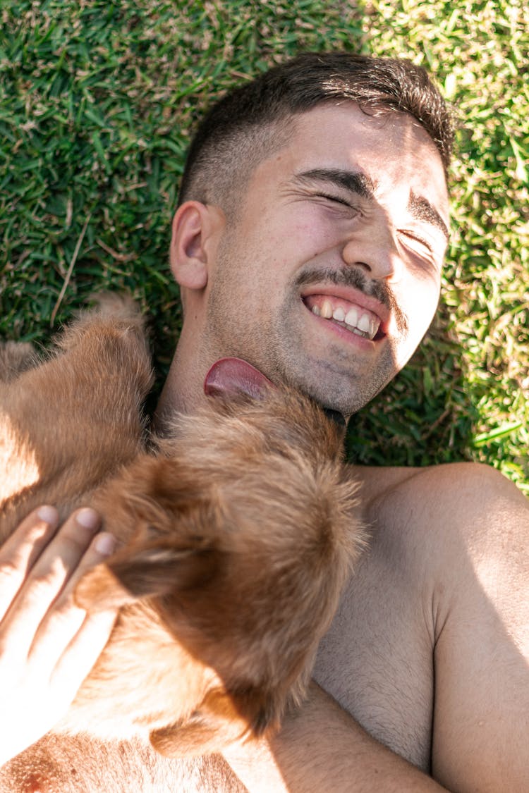 Man Cuddling A Dog