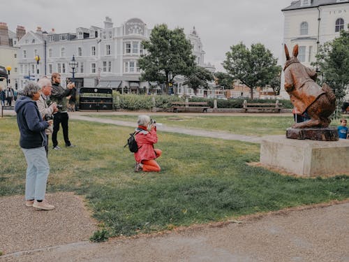 Group of People Photographing a Bronze Rabbit Statue, Llandudno, Wales, UK