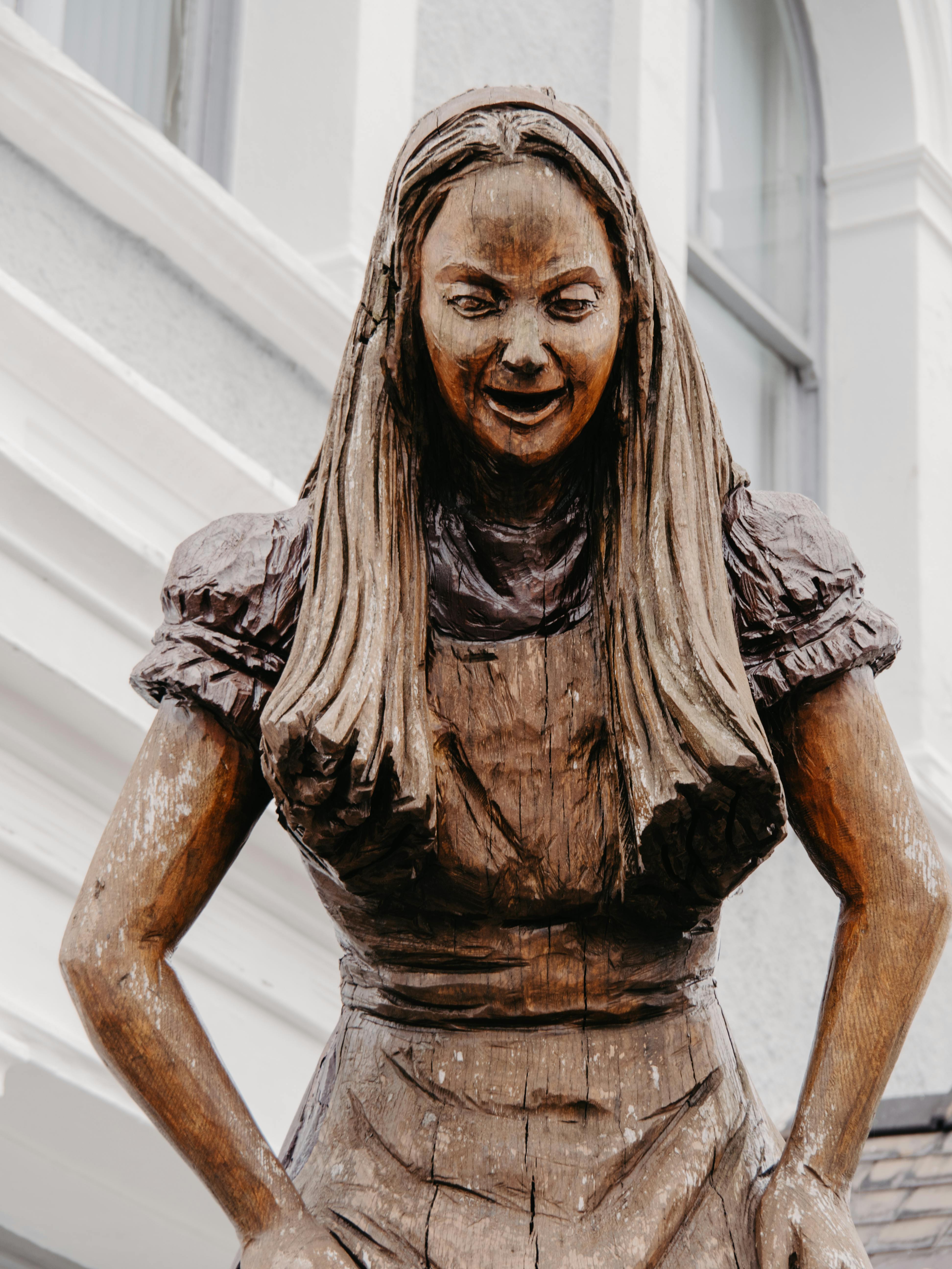 Detailed close-up of the Alice in Wonderland wooden sculpture in Llandudno, Wales.