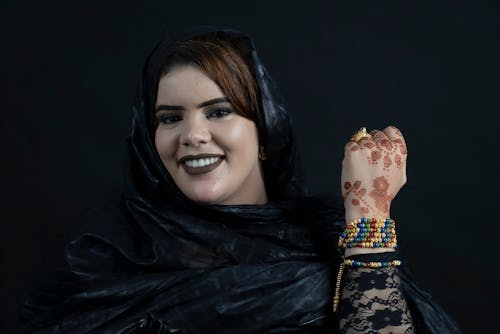 Smiling Woman with Bracelets and Henna Tattoo on Hand
