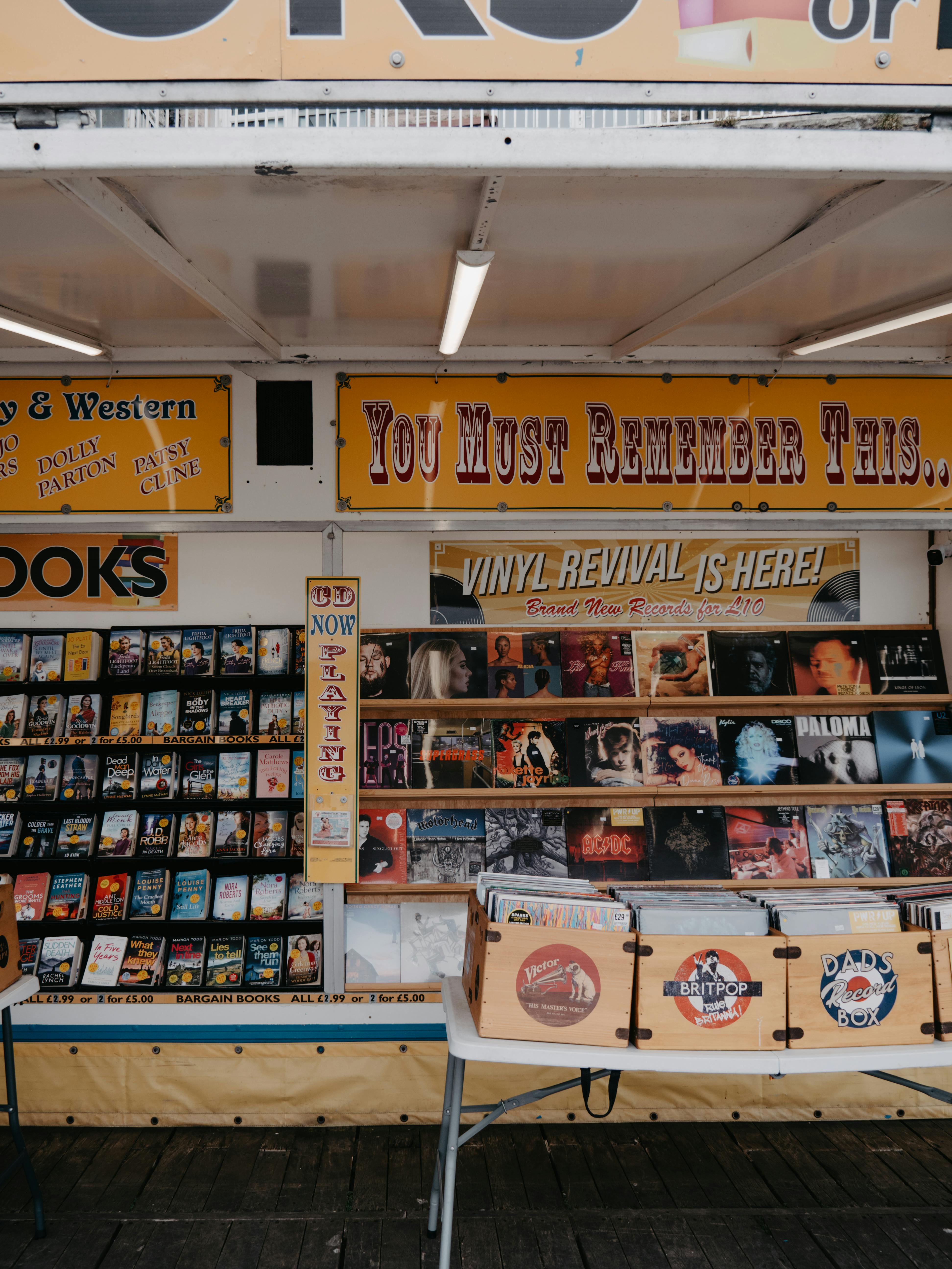 Explore a vibrant outdoor market stall featuring vinyl records and books in a nostalgic setup.