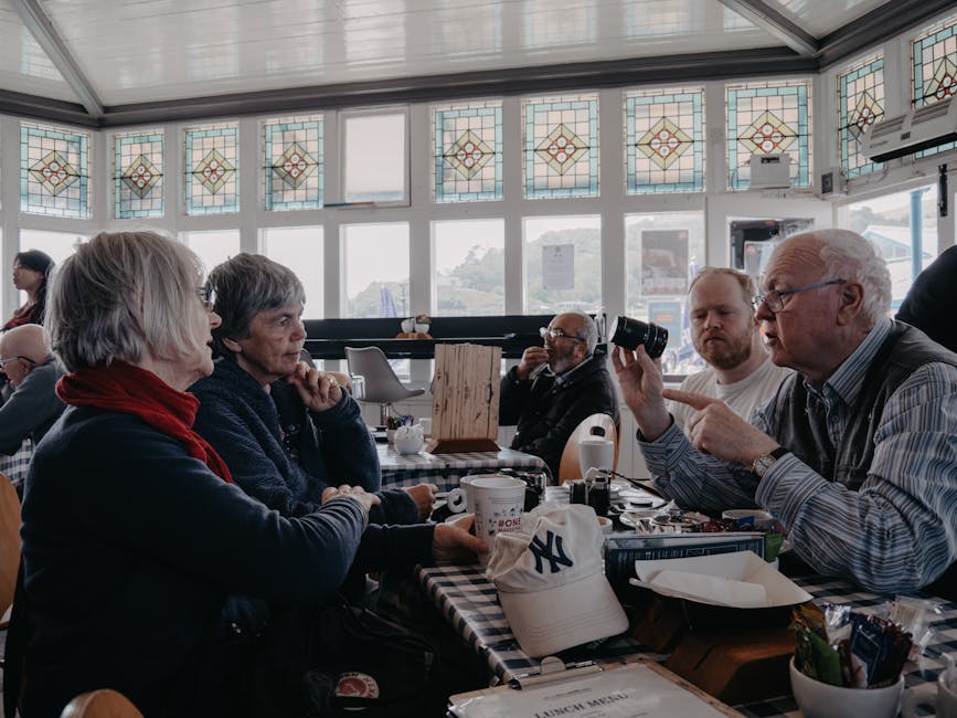 A bright, welcoming common room where seniors engage in meaningful conversations around a coffee table.. A moment pictured by Lisa from Pexels