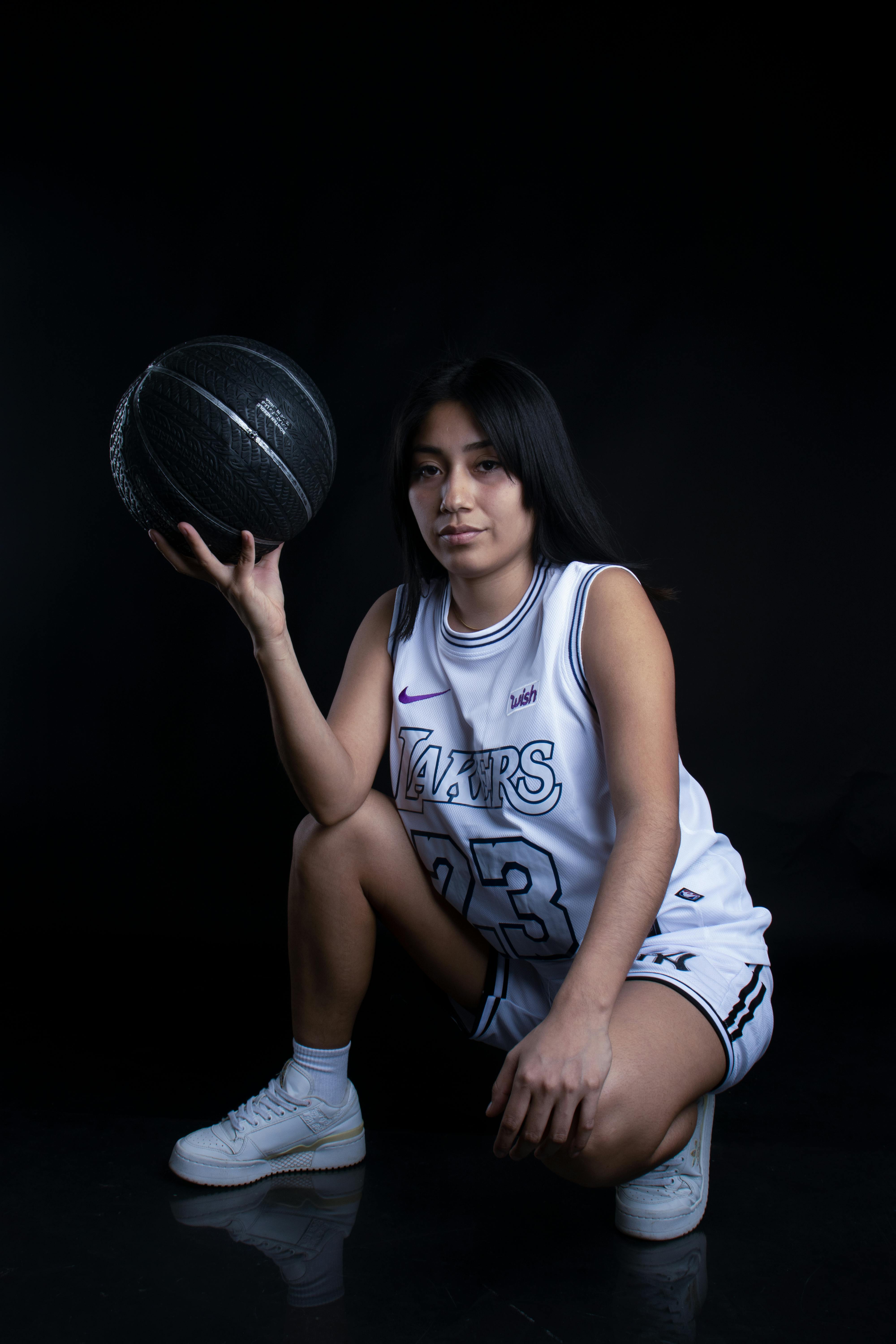 woman crouching in la lakers tank top