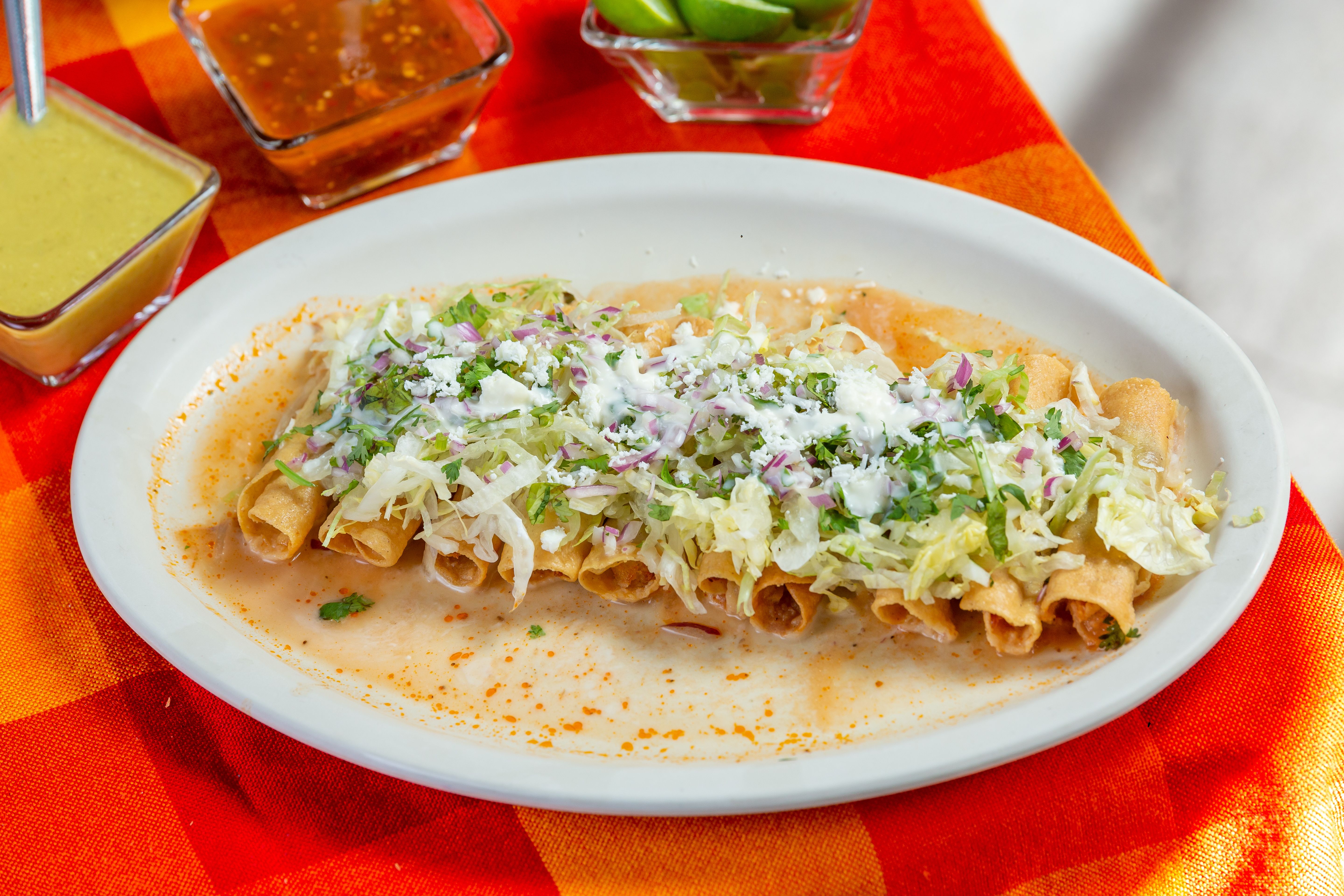 Frozen taquitos baking in an oven