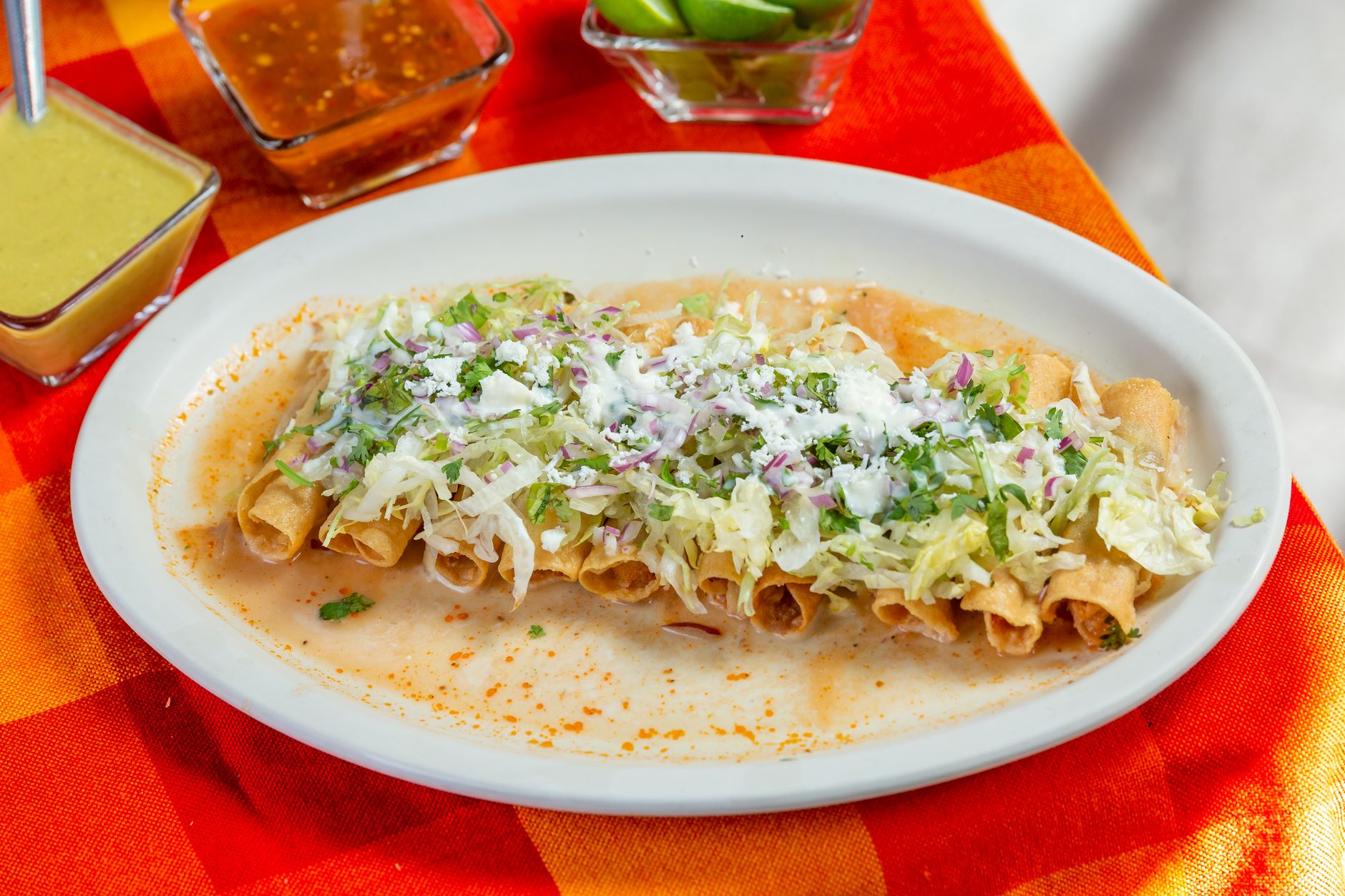 Frozen taquitos baking in an oven