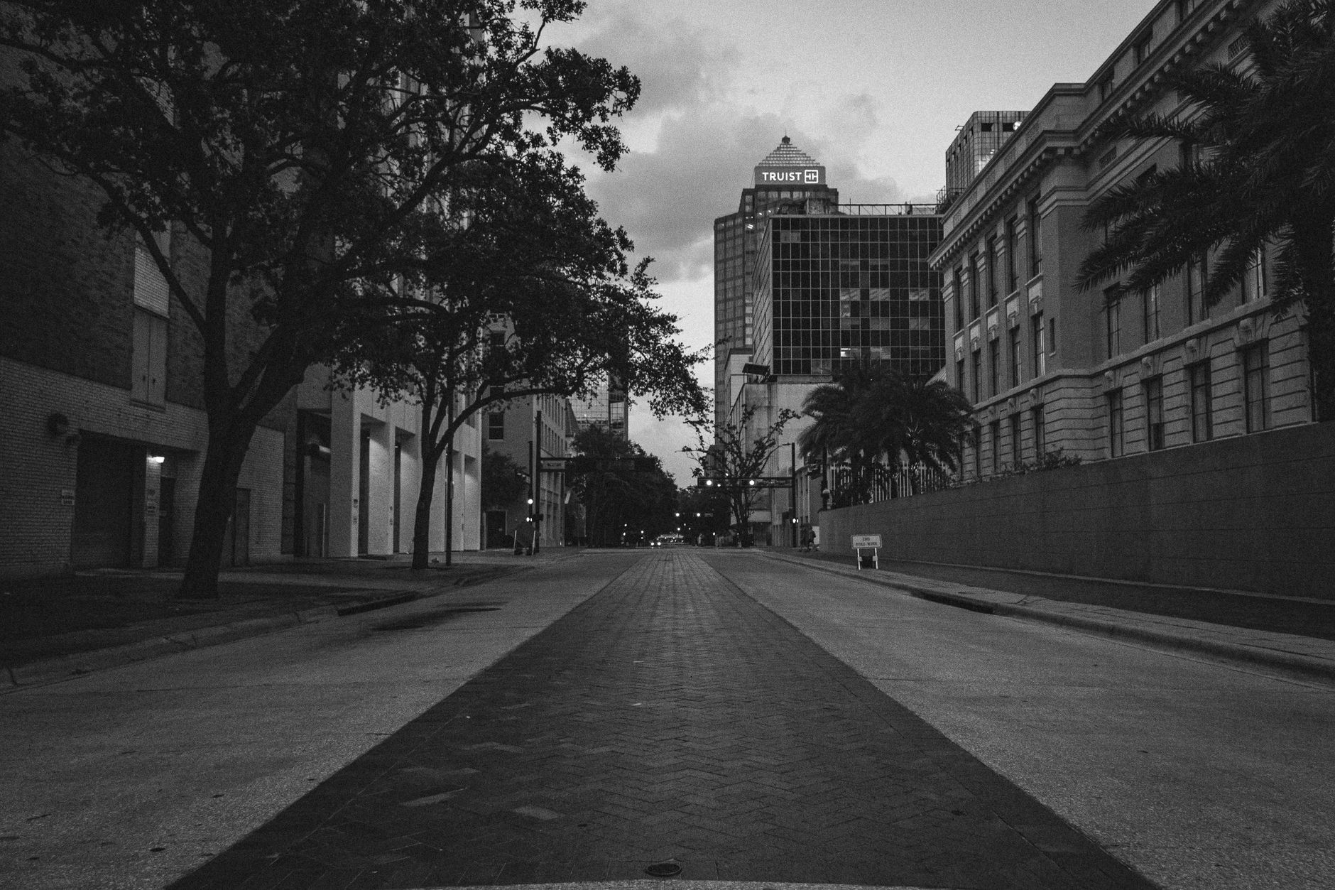 A deserted urban street in Tampa captured in black and white, highlighting city architecture and moody ambiance.