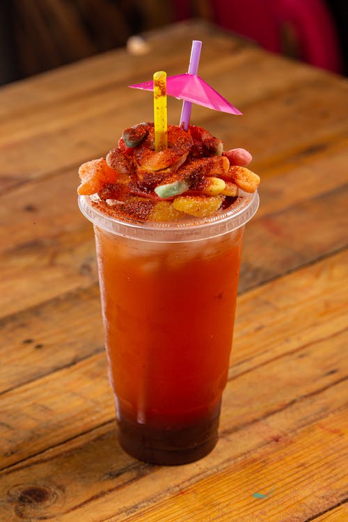 Free Cold Drink in a Plastic Cup with Fruits on Top Stock Photo