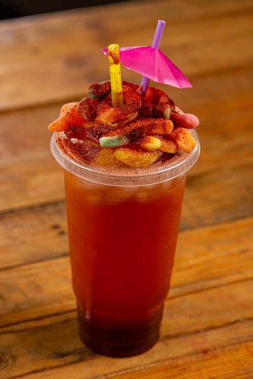 Free Cold Drink in a Plastic Cup with Fruits on Top Stock Photo