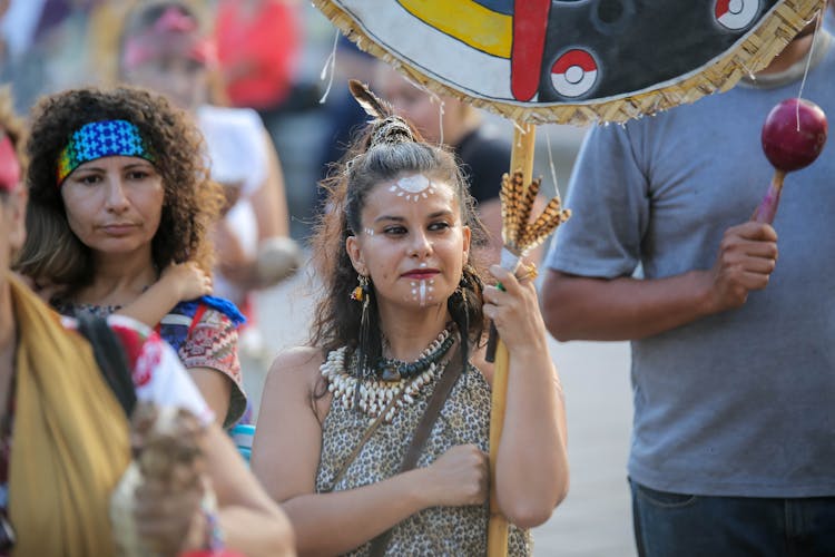 Young Woman Wearing A Tribal Costume And Face Paint Celebrating A Mexican Holiday On The Street