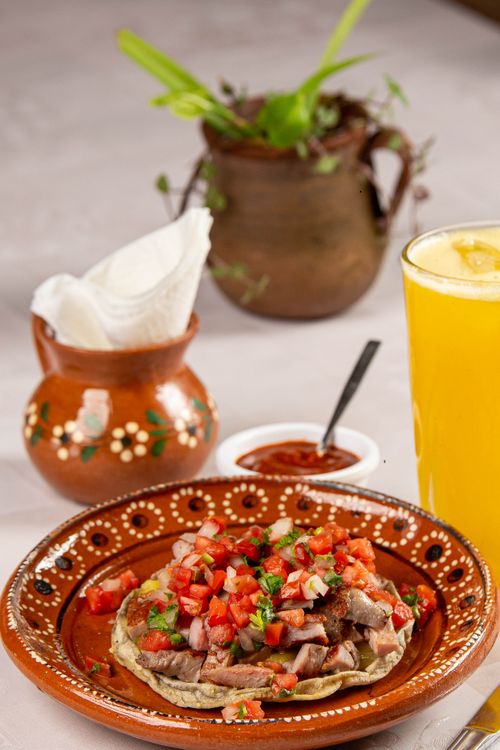 Free Traditional Mexican dish served on a decorative plate with orange juice and sauces. Stock Photo