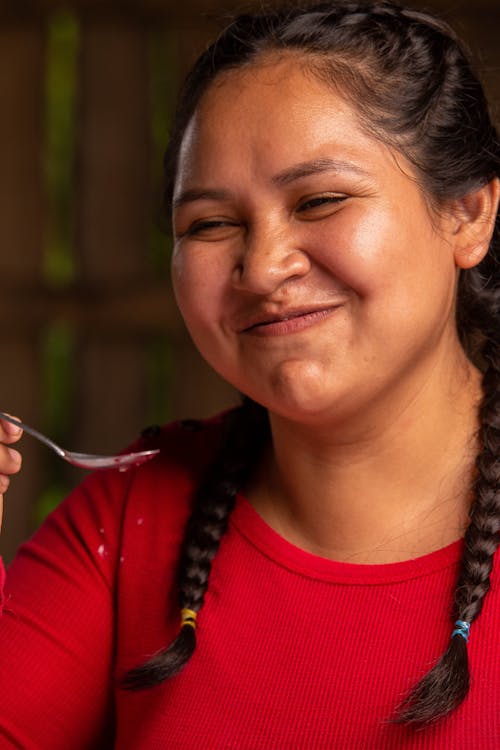 Portrait of Woman Trying out Food with Spoon