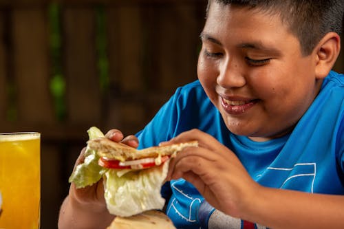 Smiling Boy Eating Tortilla