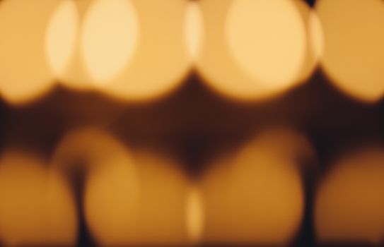 Blurred abstract orange bokeh lights creating a warm and cozy atmosphere.