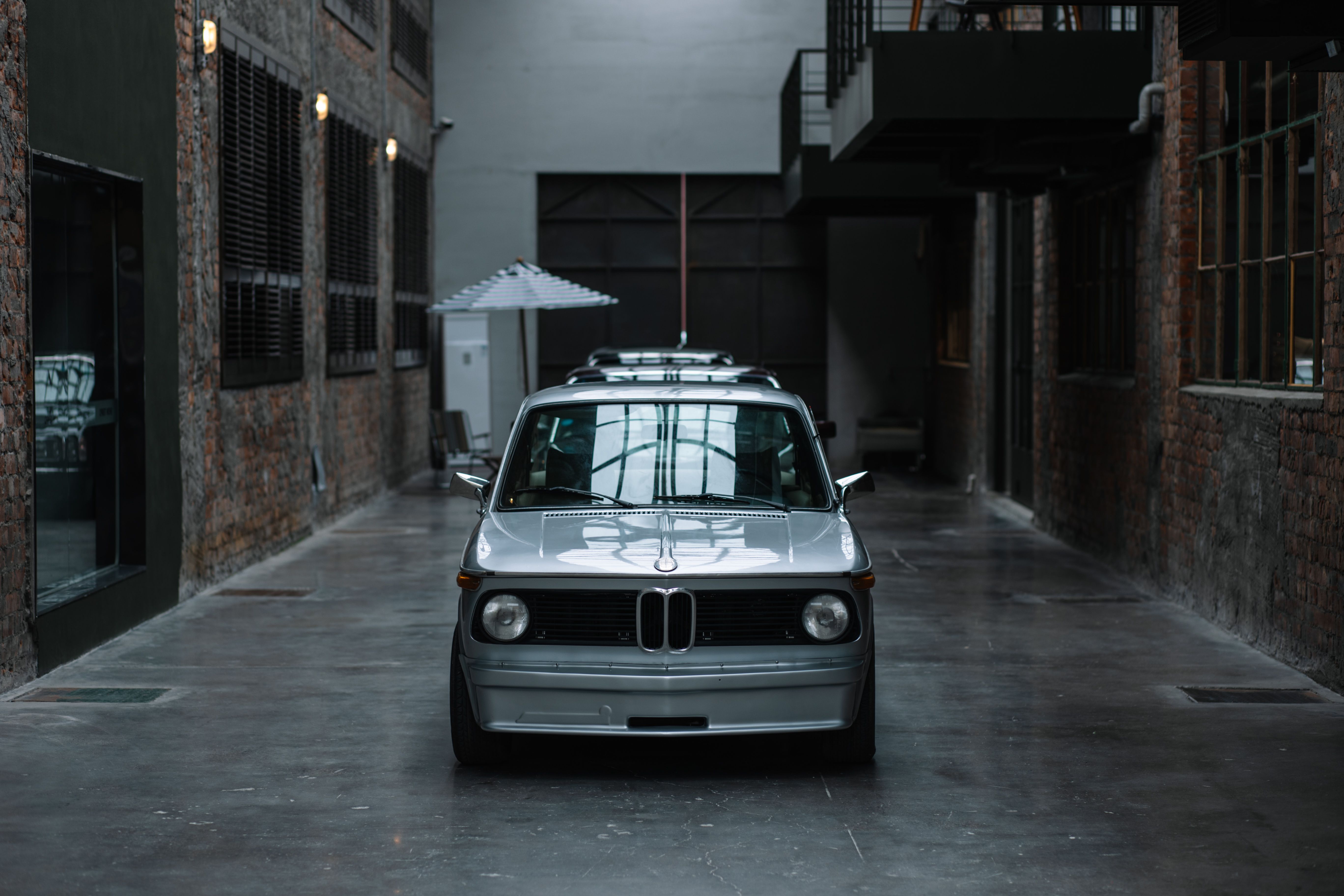 White BMW Car Parked in a Yard · Free Stock Photo