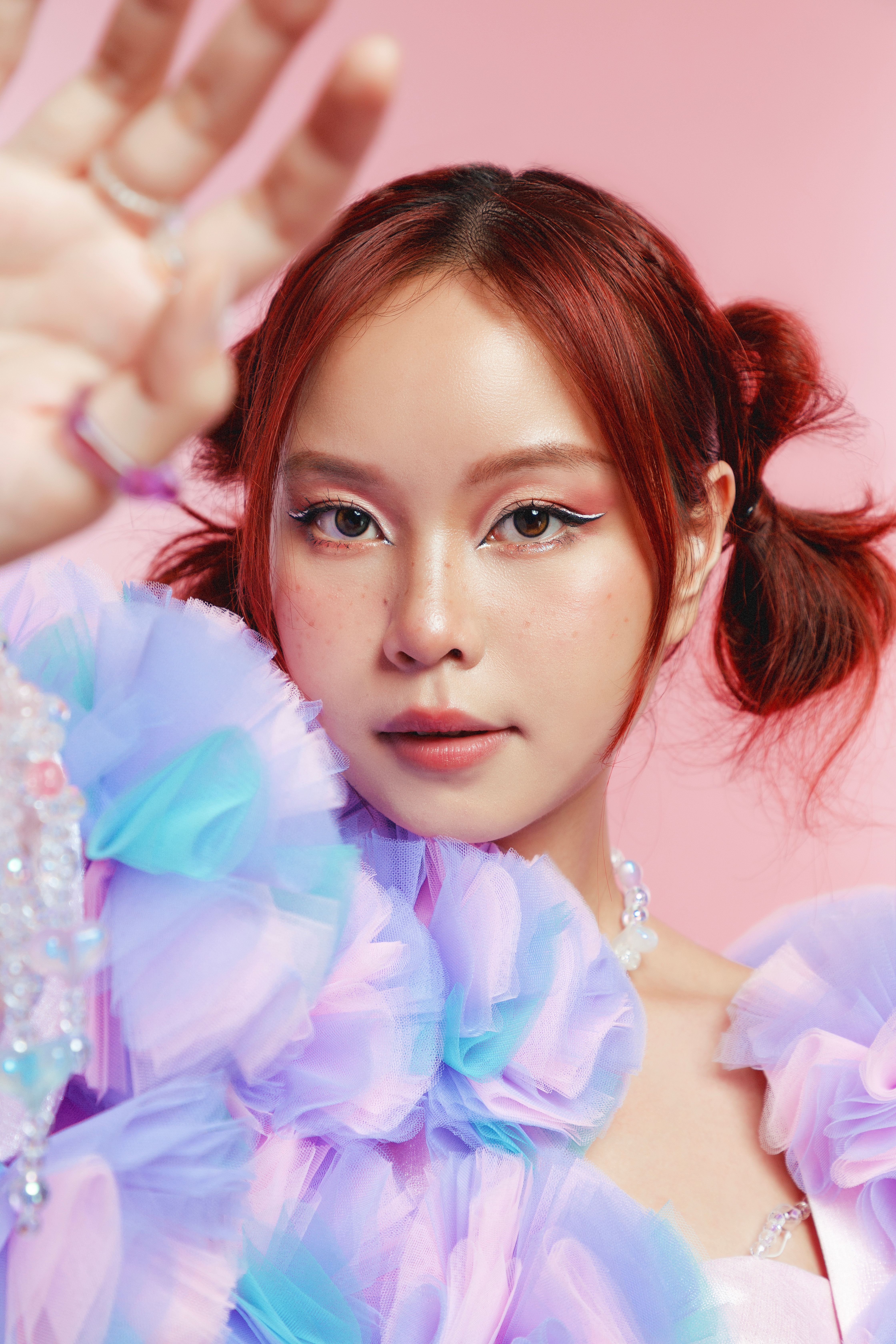 Vibrant portrait of a stylish young woman with colorful fashion and makeup.