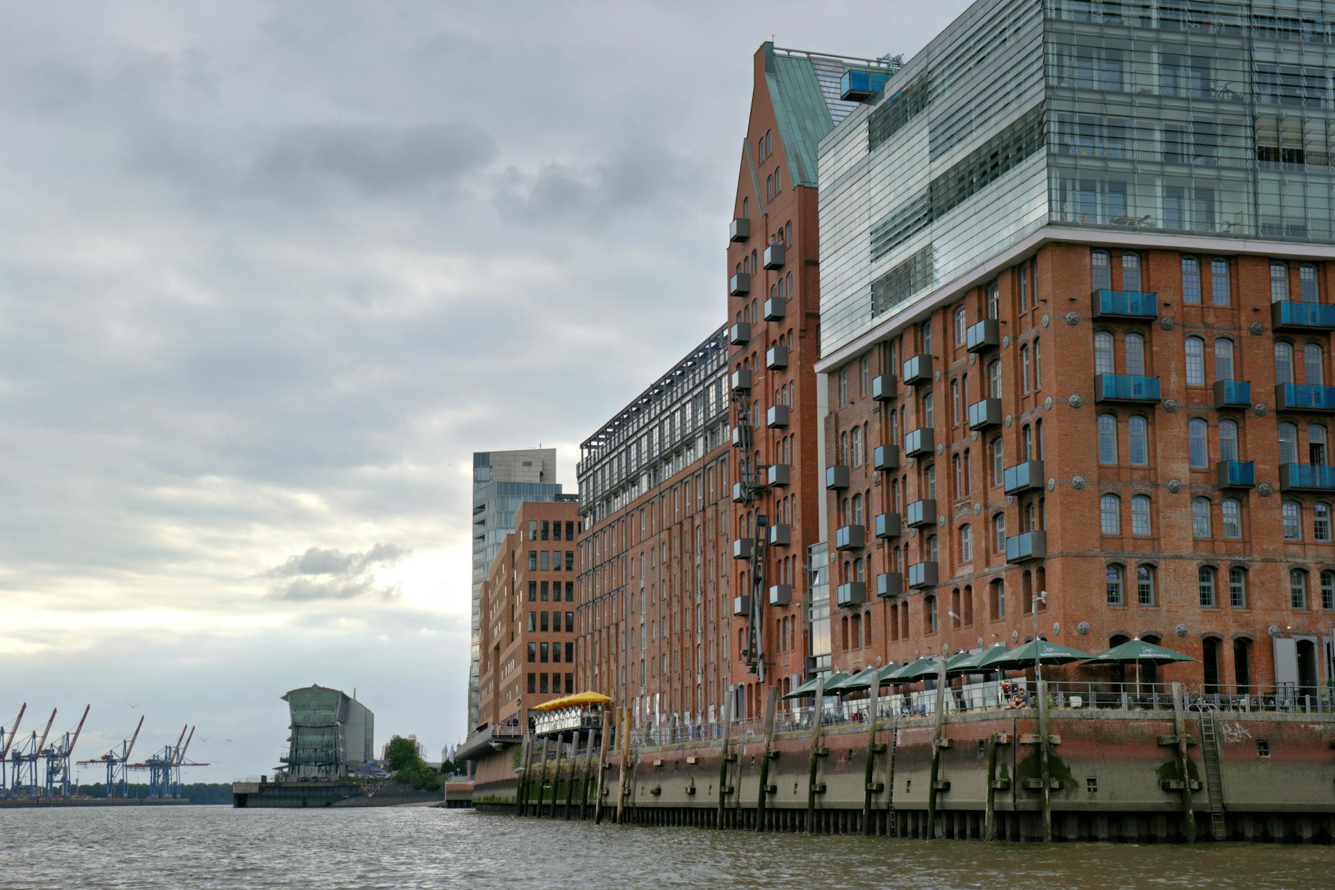 View of modern and historic buildings along the waterfront in Hamburg, showcasing urban architecture.