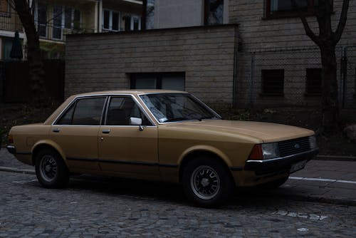 Brown Ford Granada on Cobblestone Street