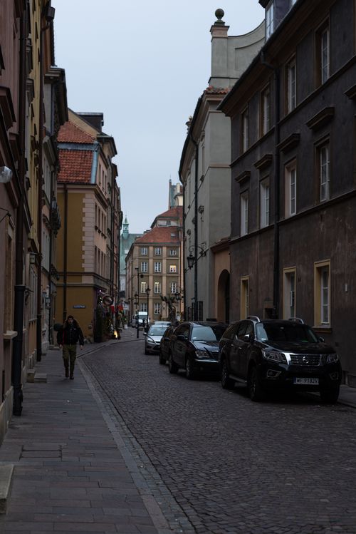 Free Picturesque European old town street with historic buildings and cobblestone pavement. Stock Photo
