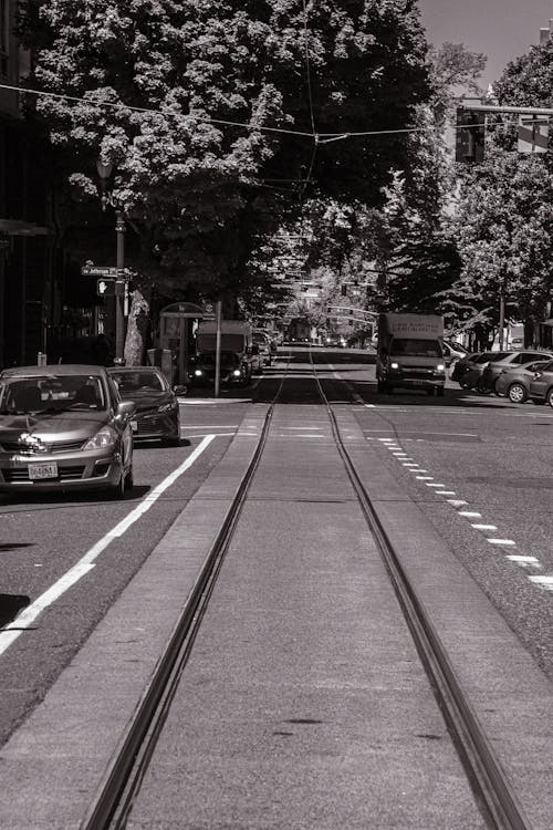 Black and White Photo of a City Street with Tram Rails