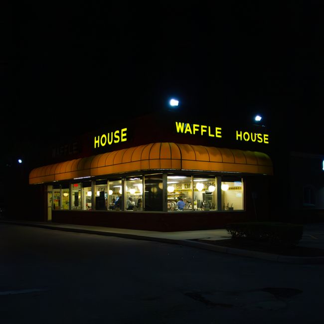 Illuminated Waffle House restaurant in Tampa, FL, captured at night, showcasing urban nightlife.