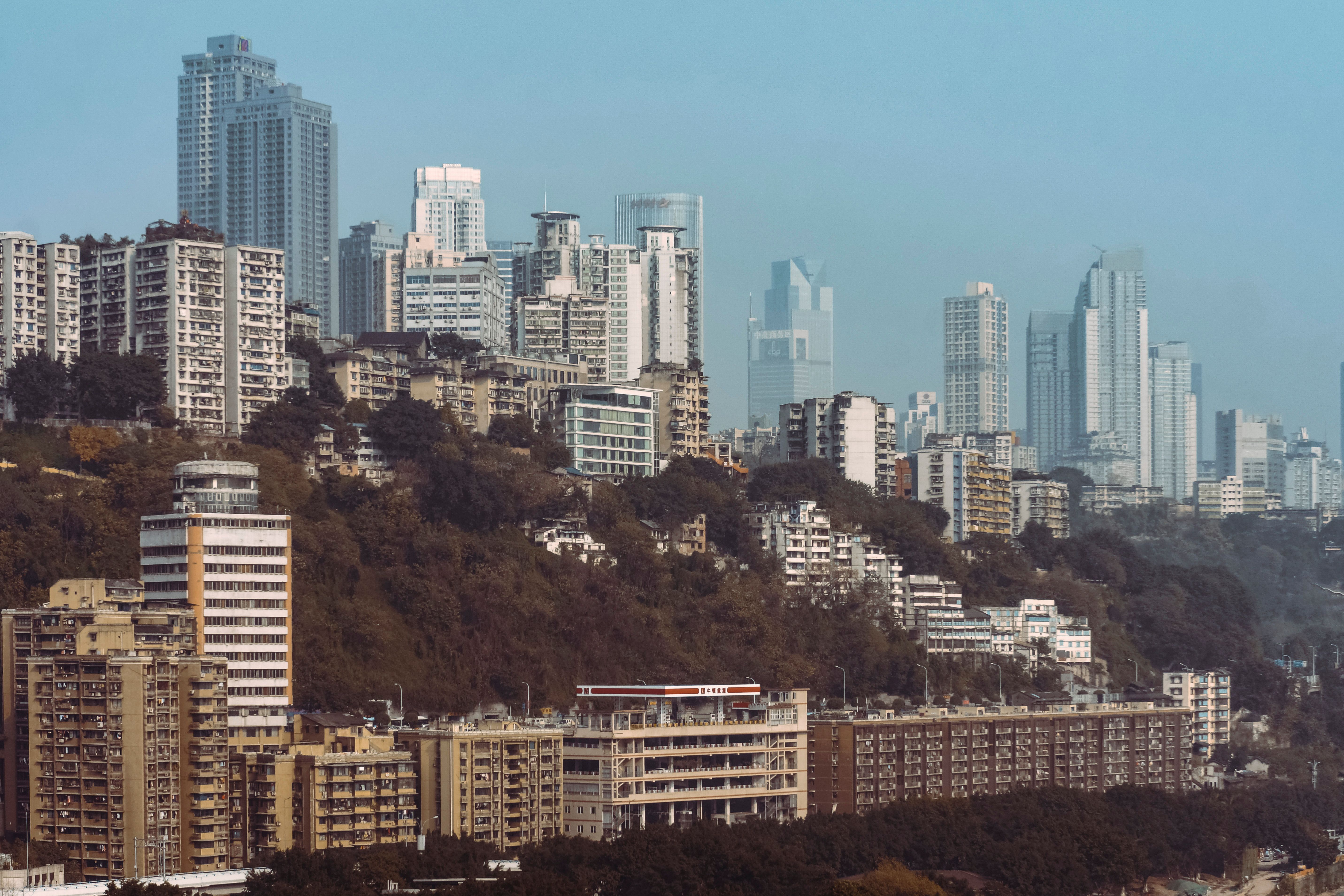 Concrete office towers and computer market sheds at Nehru Place with crowds on the raised plaza
