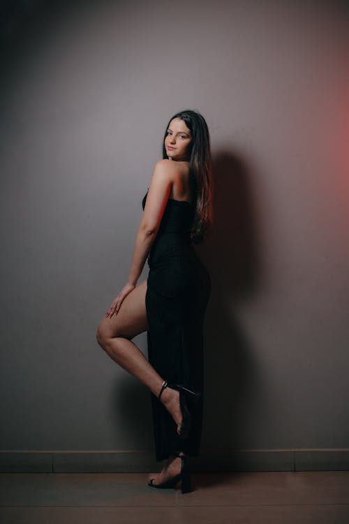 Woman in Black Dress on Gray Background