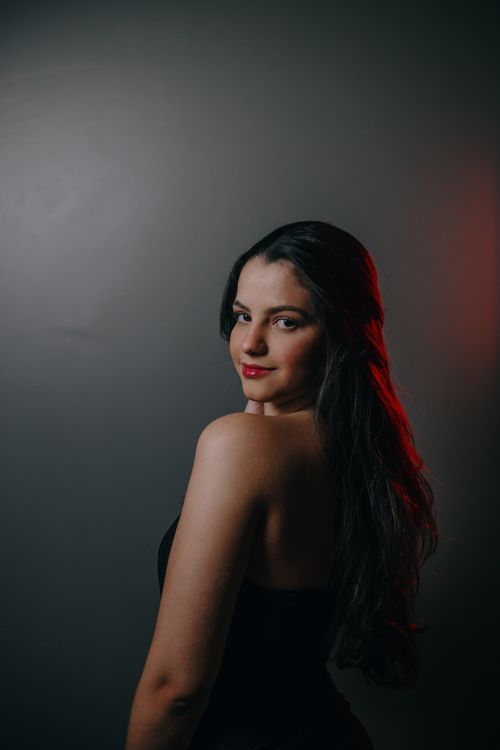 Free Sophisticated portrait of a brunette woman posing in studio with dramatic lighting. Stock Photo