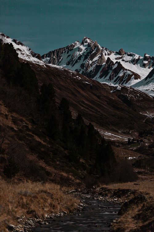 Free Breathtaking view of a snow-capped mountain range under a clear night sky, perfect for nature and travel enthusiasts. Stock Photo