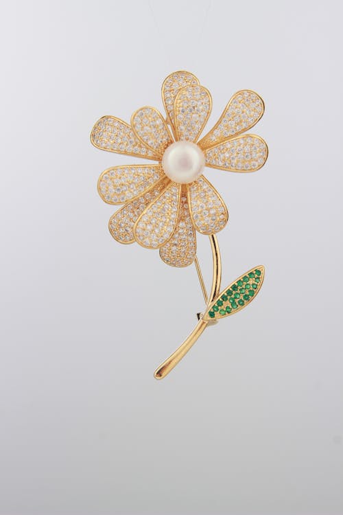 Golden Flower-Shaped Brooch Decorated with Diamonds, Emeralds and a Pearl