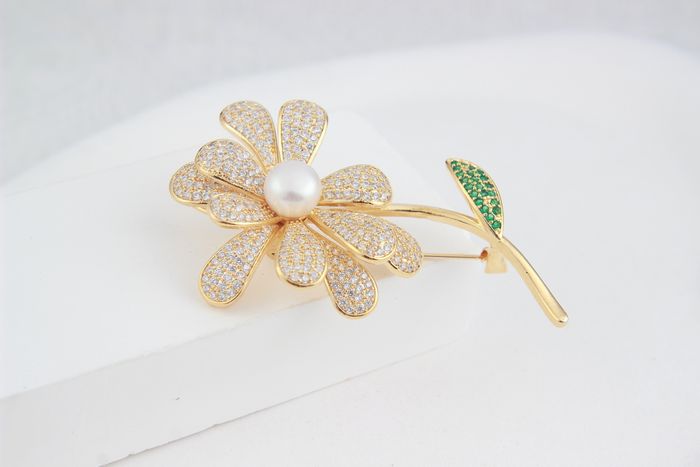 Golden flower-shaped brooch