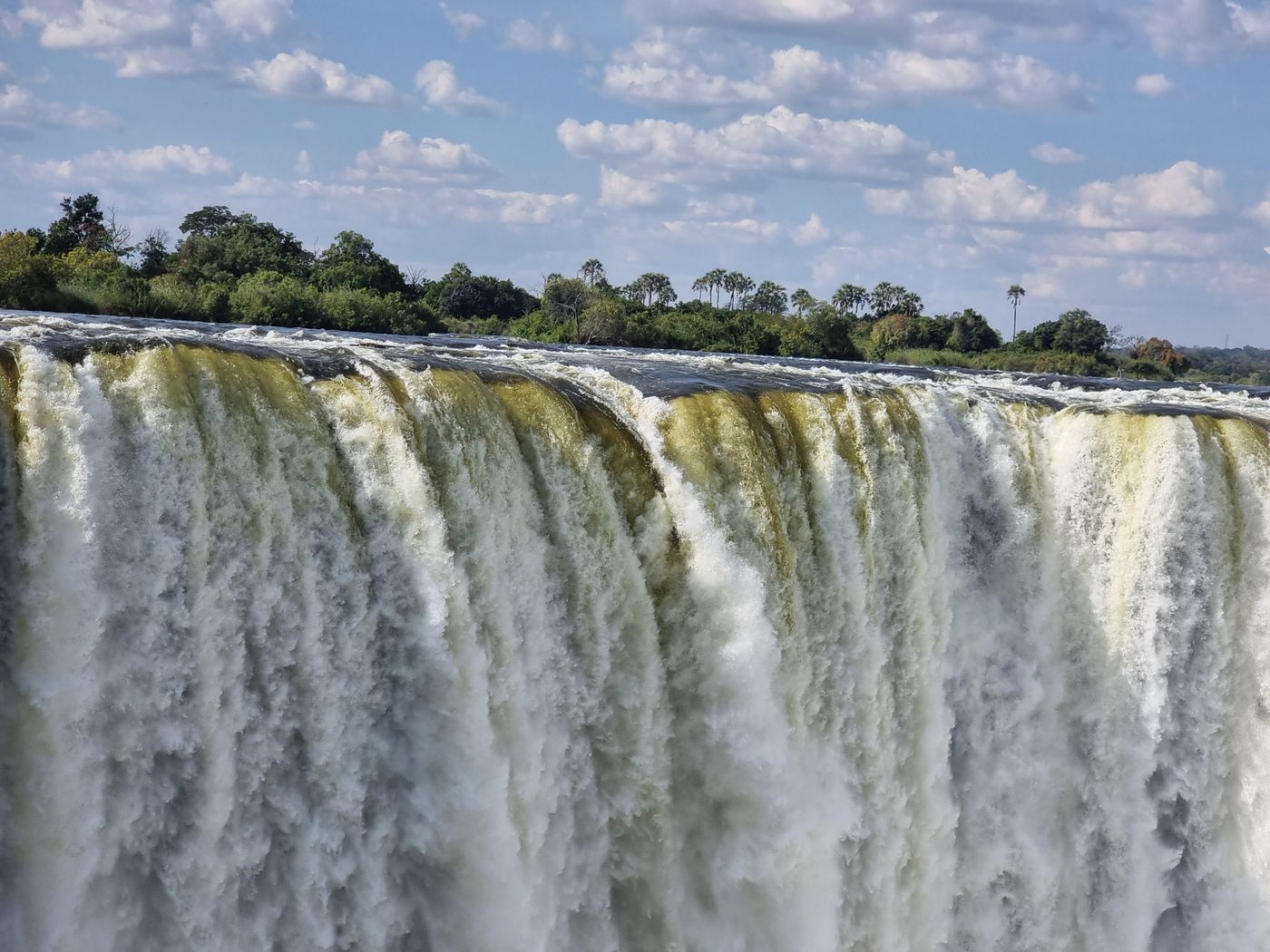 Victoria Falls in full flow, surrounded by green