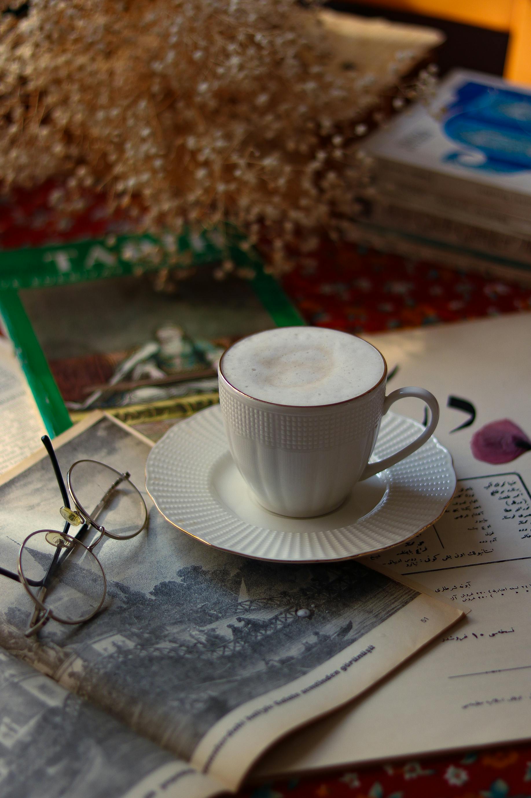 A warm coffee cup on vintage papers creates a cozy and nostalgic ambiance.