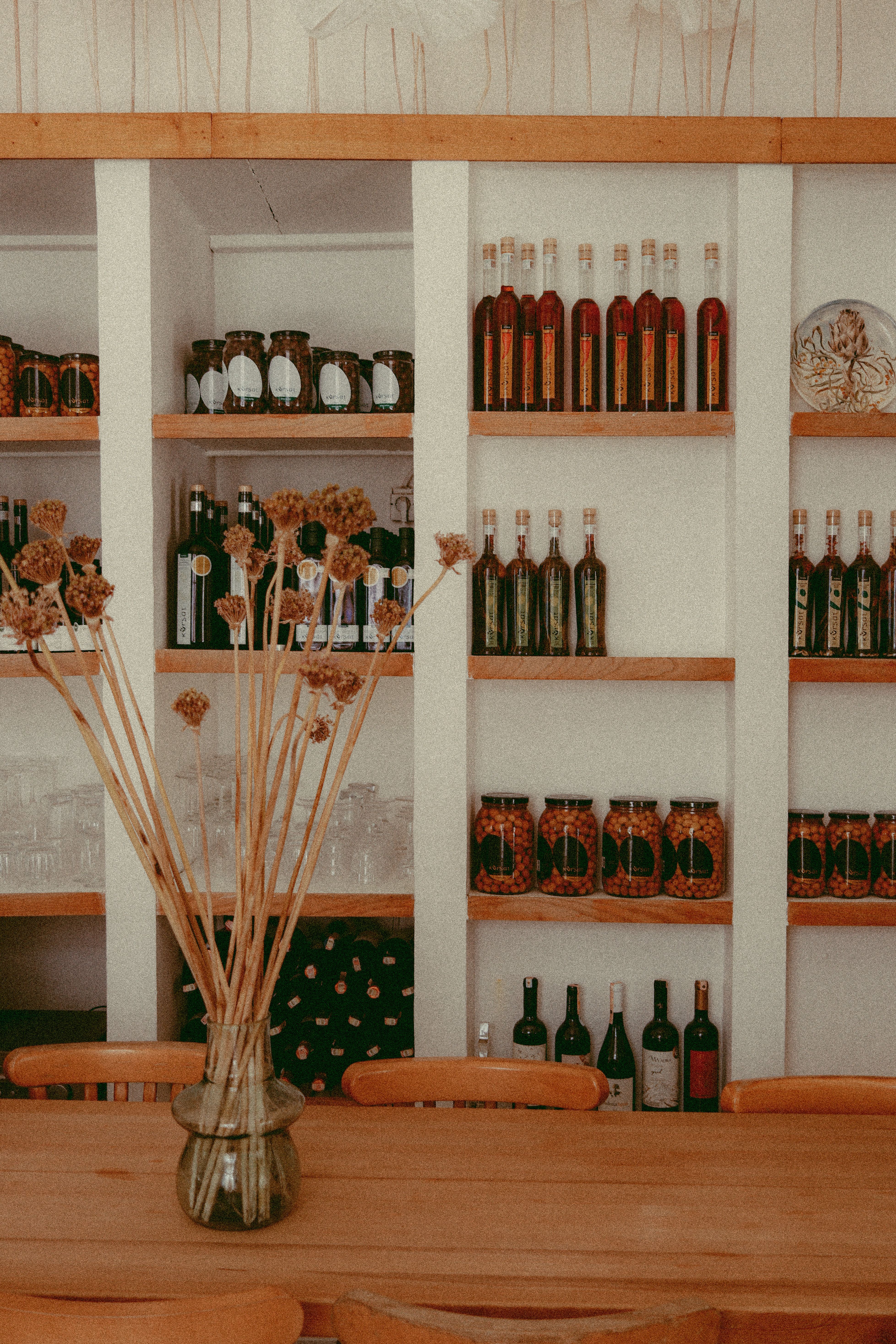 Shelves of Jars with Preserves and Wine Bottles · Free Stock Photo