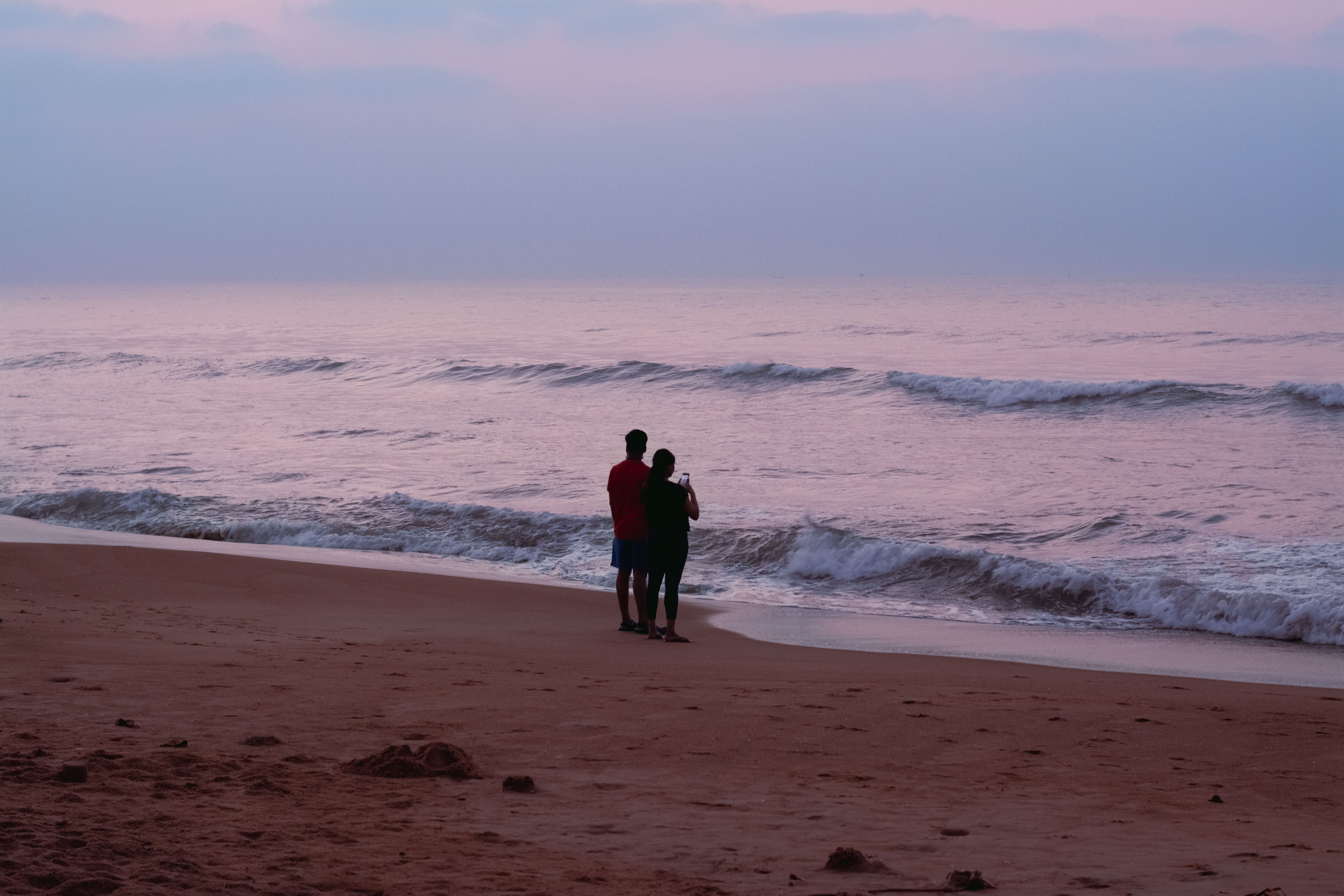 Couple on Beach at Dusk · Free Stock Photo