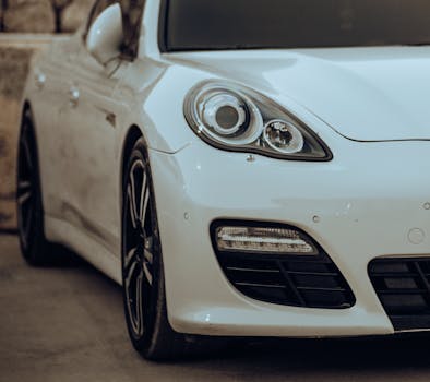 Detailed front close-up of a sleek white sports car showcasing its luxury design.