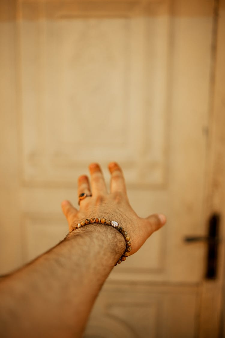 Arm Of A Man Reaching Toward The Door 