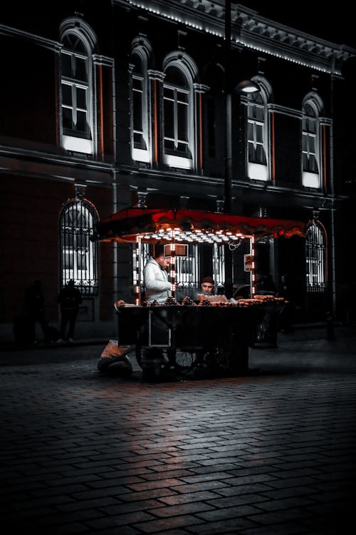 A Food Cart on the Street in the Evening 
