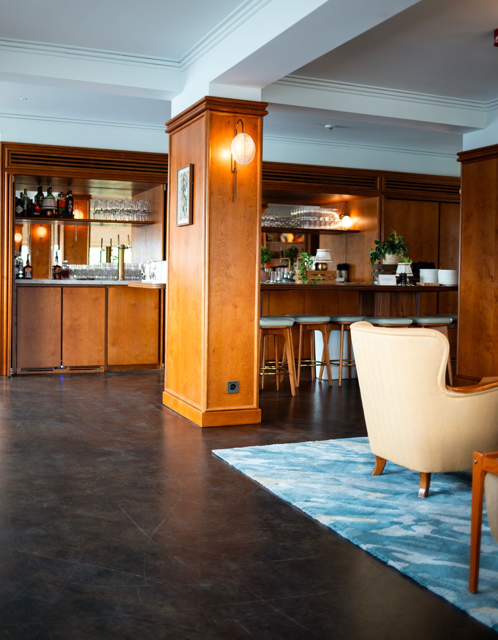 warm modern hotel lounge with walnut wood, linen seating, and soft natural light