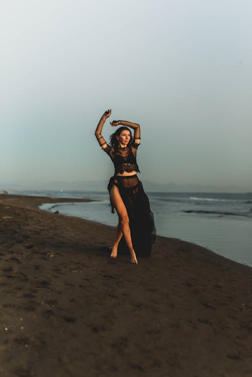 Woman in Black Dress Posing on Beach · Free Stock Photo