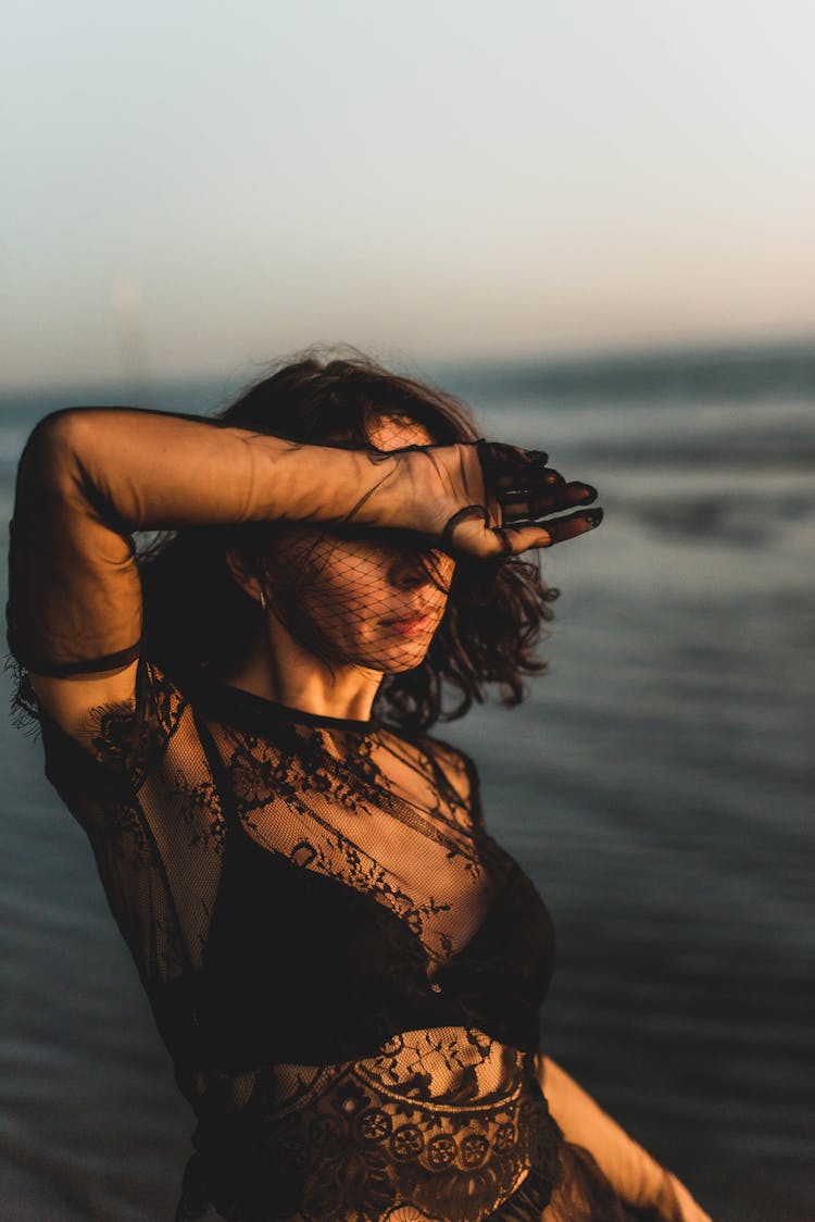 Woman In Black Clothes Posing And Covering Face