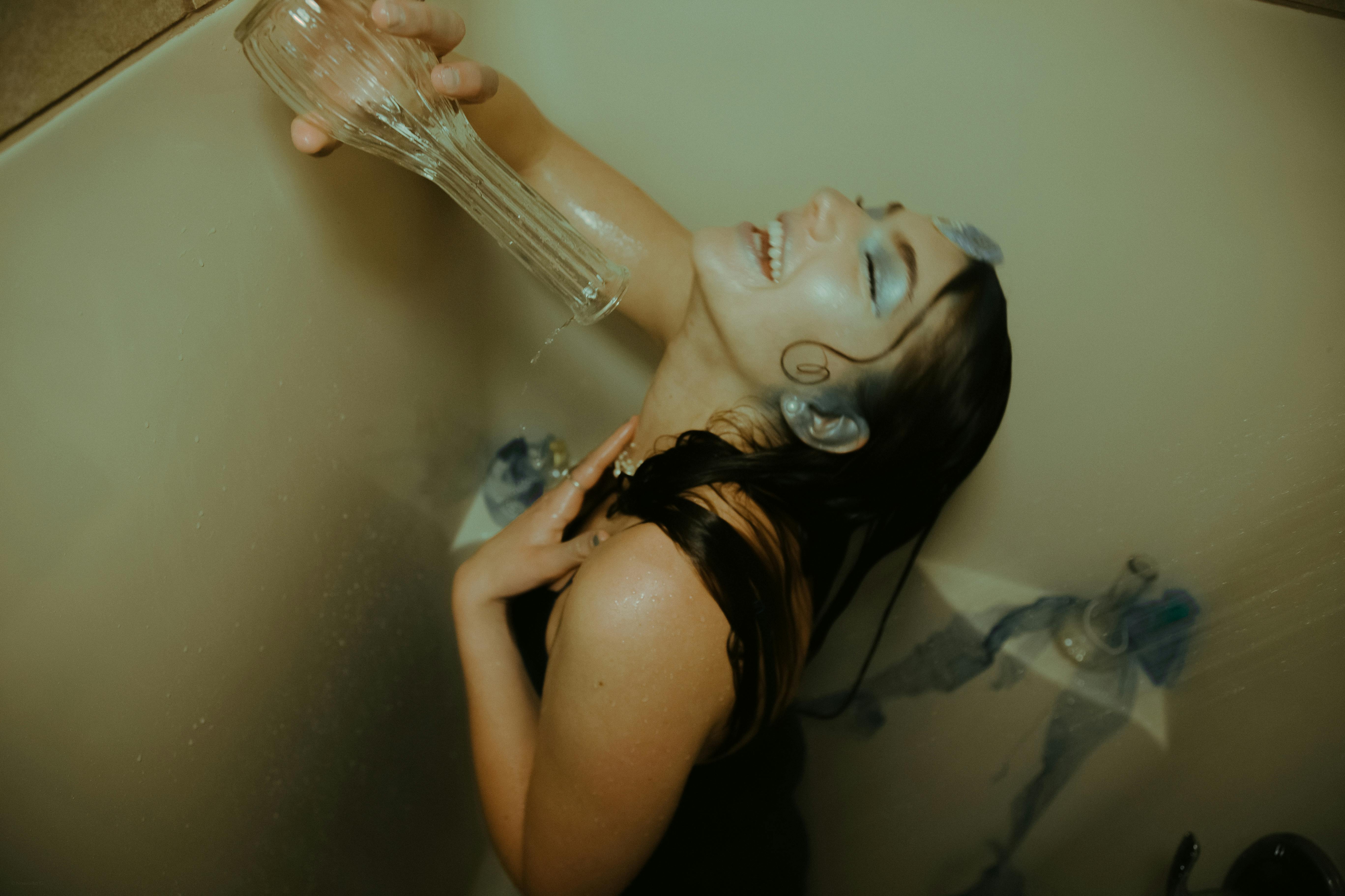 woman pouring water on herself